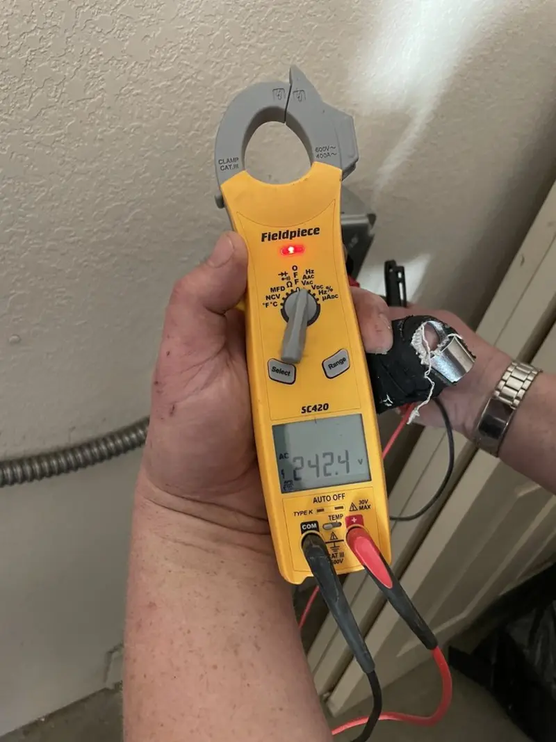Voltage testing with clamp meter during Electrical Installation Services in Bangor